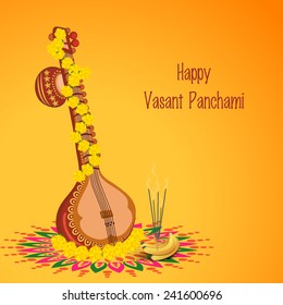 Traditional musical instrument Veena with religious offerings on rangoli for Hindu Community festival, Vasant Panchami celebration.