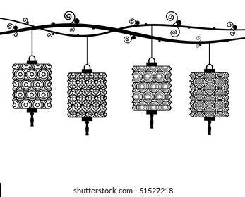 traditional paper lanterns in black and white hanging from branches