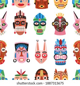 Traditional ritual or ceremonial tribal masks vector flat illustration. Colorful shapes of human face or animal's muzzle seamless pattern. Ethnic decorative masquerade attribute wallpaper template