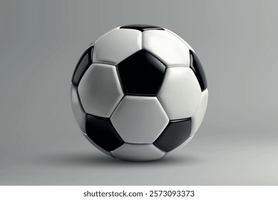 A traditional soccer ball with black and white panels placed on a plain gray surface