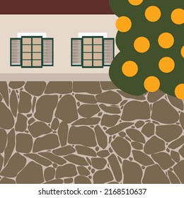 Traditional spanish house with stone wall and orange tree. Typical mediterranean house with orange harvest.