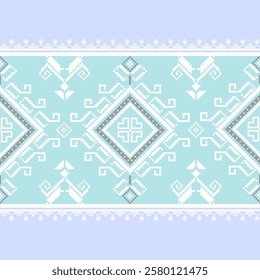 A traditional Ukrainian cross-stitch pattern featuring pixelated floral and geometric repeats in blue, white and grey. Often used in traditional clothing and decorative textiles.