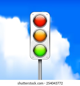 Traffic light against a blurred background of blue sky with clouds