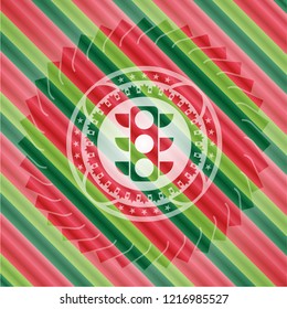 traffic light icon inside christmas colors emblem.