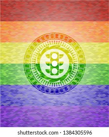 traffic light icon inside emblem on mosaic background with the colors of the LGBT flag