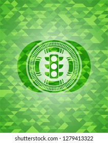 traffic light icon inside green mosaic emblem