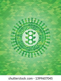 traffic light icon inside green emblem with mosaic background