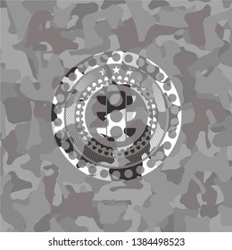 traffic light icon inside grey camouflage emblem