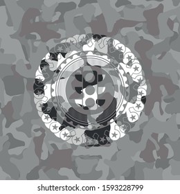 traffic light icon inside grey camouflaged emblem
