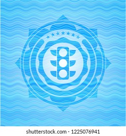 traffic light icon inside water wave representation badge background.