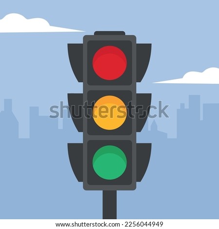Traffic light on the background of the city and the blue sky