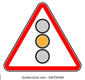 Traffic light, semaphore on triangle road sign.