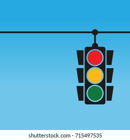 Traffic lights hanging on blue background