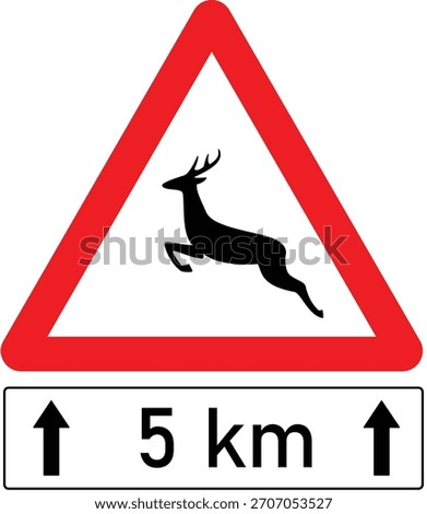 Traffic sign warns about wild animals crossing the road with blue cloudy sky