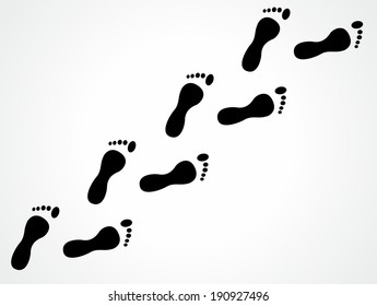 Trail of black human bare footsteps