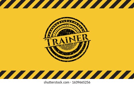 Trainer black grunge emblem inside yellow warning sign. Vector Illustration. Detailed.