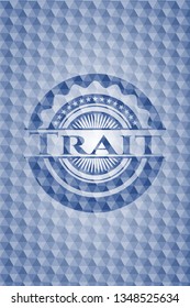 Trait blue badge with geometric background.