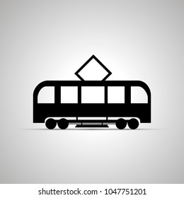 Tram silhouette, side view simple black icon with shadow