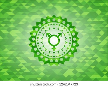 transgender icon inside green mosaic emblem