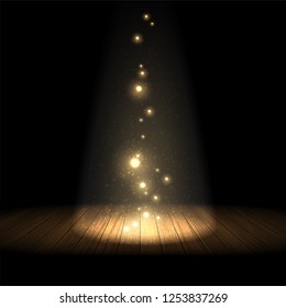 Transparent light with bright highlights illuminates part of the wooden scene  on the black background.