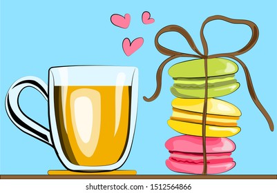 Transparent mug with tea and colored french macaroons on a blue background without shadow closeup.