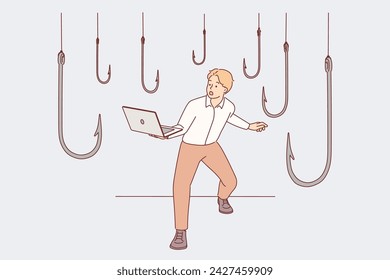 Trap hooks around man with laptop as metaphor for dangers of deception and scammers on internet. Guy visiting untrustworthy website on computer run risk of being tricked by online phishing scammers.