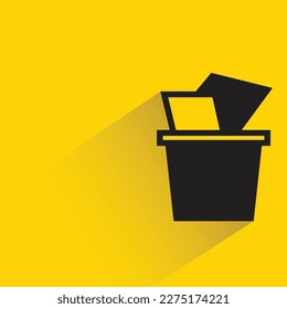 trash bin with shadow on yellow background