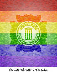 trash can icon inside emblem on mosaic background with the colors of the LGBT flag. 