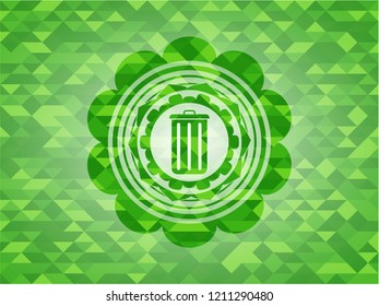 trash can icon inside green emblem with triangle mosaic background