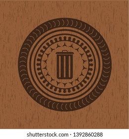 trash can icon inside wooden emblem