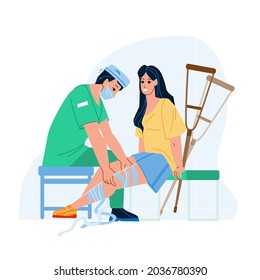 In Traumatology Patient Treatment Trauma Vector. Traumatologist Doctor Treat Woman With Broken Leg In Traumatology Hospital Cabinet And Applying Elastic Bandage. Characters Flat Cartoon Illustration