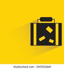 travel bag with shadow on yellow background