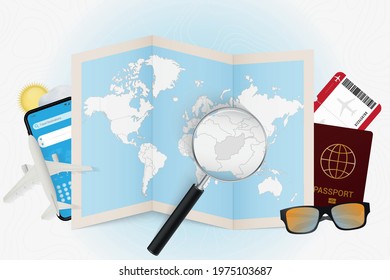 Travel destination Afghanistan, tourism mockup with travel equipment and world map with magnifying glass on a Afghanistan. Trip template.