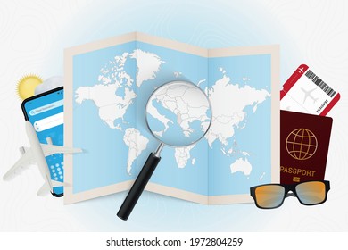 Travel destination Albania, tourism mockup with travel equipment and world map with magnifying glass on a Albania. Trip template.