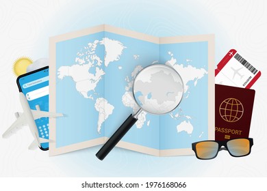 Travel destination Kazakhstan, tourism mockup with travel equipment and world map with magnifying glass on a Kazakhstan. Trip template.