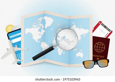 Travel destination Uzbekistan, tourism mockup with travel equipment and world map with magnifying glass on a Uzbekistan. Trip template.