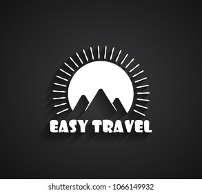 Travel Logo with white mountains on the sunset background and shadow