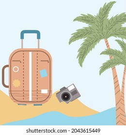 travel suitcase with camera in the beach
