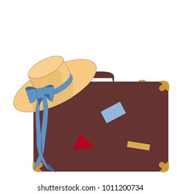 Travel suitcase and hat on luggage