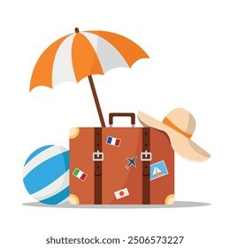 Travel suitcase with stickers, umbrella, hat and beach ball. Travel, vacation and tourism concept.