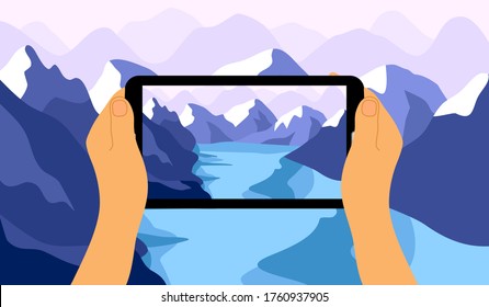 Travel and take picture. Mobile photography concept. Man hand holding smartphone and looking photo of mountain river landscape on screen to make camera focus and shutter.