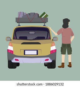 Travel vehicle with various luggage accessories With a man standing by looking somthing.