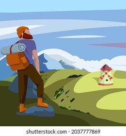Traveler with a backpack enjoys the beautiful nature and the windmill