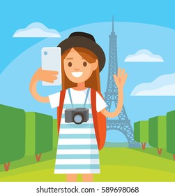 Traveler girl makes selfie by Eiffel tower