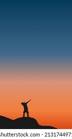 Traveler standing on top of a mountain with sunset background. Exploration, hiking, adventure tourism, and travel.
