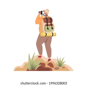 Traveller with backpack standing on top of mountain and looking through camera.