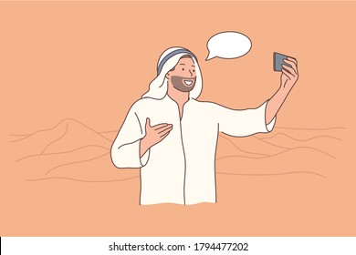 Travelling, tourism, smartphone, arabia concept. Young happy smiling cheerful man guy muslim arab witn kandura making selfie on mobile phone in desert. Communication through device and showing views.