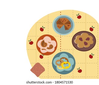 
Treats on the table chocolate pie blackberry pie bagels donuts with sprinkles on plates tablecloth with apple pattern