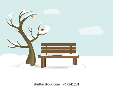 tree and a bench with snow on them and foliage. Late Autumn, early winter