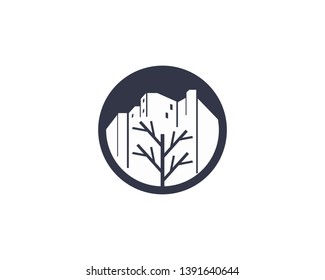 tree branch in front of large building scene in circle